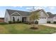 Gray house with two-car garage and landscaped lawn at 6114 Bellastead Dr, Charlotte, NC 28214