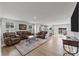 Spacious living room with leather furniture and hardwood floors at 6114 Bellastead Dr, Charlotte, NC 28214