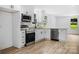 Modern kitchen with white cabinets, granite, and island at 310 Dunham Ave, Salisbury, NC 28146