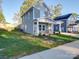 Two-story gray house with a stone facade and covered porch at 558 Geneva Cir, Gastonia, NC 28056