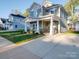 Two-story gray house with a stone facade and covered porch at 558 Geneva Cir, Gastonia, NC 28056