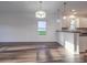 Dining room with hardwood floors, chandelier, and kitchen view at 558 Geneva Cir, Gastonia, NC 28056