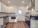 Modern kitchen with white cabinets, stainless steel appliances, and granite countertops at 558 Geneva Cir, Gastonia, NC 28056