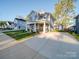 Two-story gray house with a stone facade and covered porch at 558 Geneva Cir, Gastonia, NC 28056