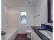 Bathroom with dark vanity, tub, and window at 558 Geneva Cir, Gastonia, NC 28056