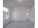 Well-lit bedroom with carpet, double doors, and access to another room at 558 Geneva Cir, Gastonia, NC 28056
