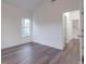 Bright bedroom with wood-look floors and access to hallway and stairs at 558 Geneva Cir, Gastonia, NC 28056