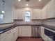 Modern kitchen with white cabinets, granite countertops, and stainless steel appliances at 558 Geneva Cir, Gastonia, NC 28056