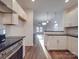 Modern kitchen with island, white cabinets and stainless steel appliances at 558 Geneva Cir, Gastonia, NC 28056