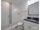 Modern bathroom with a walk-in shower and dark vanity at 558 Geneva Cir, Gastonia, NC 28056