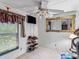 Bright bedroom with window coverings, ceiling fan, and shoe rack at 7676 Shoupes Grove Church Rd, Hickory, NC 28612