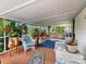 Relaxing screened porch with wicker furniture and wood flooring at 7676 Shoupes Grove Church Rd, Hickory, NC 28612