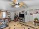 Bright living room with a ceiling fan, TV, and western-themed decor at 7676 Shoupes Grove Church Rd, Hickory, NC 28612