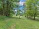 Wooded area with a gently sloping grassy yard at 7676 Shoupes Grove Church Rd, Hickory, NC 28612