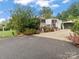 Mobile home with a carport and a well-maintained yard at 7676 Shoupes Grove Church Rd, Hickory, NC 28612