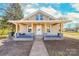 Beige house with a front porch and landscaping at 185 17Th Se St, Hickory, NC 28602