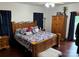 Main bedroom with king-size bed, wood furniture, and hardwood floors at 1982 Hopewell Church Rd, Hiddenite, NC 28636