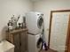 Laundry room with washer, dryer, and storage cabinet at 1982 Hopewell Church Rd, Hiddenite, NC 28636