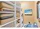 Convenient laundry room with washer, dryer, and shelving at 215 N Pine St # 3705, Charlotte, NC 28202