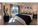 Spacious bedroom with a king-size bed, stylish decor, and a large window at 3018 Pirates Pl, Charlotte, NC 28216