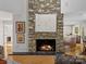 Stunning stone fireplace as a focal point in the living area at 3 Courageous St, Lake Wylie, SC 29710