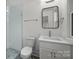 Small bathroom with single vanity, shower, and geometric tile floors at 3109 Colyer Pl, Charlotte, NC 28205