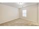 Small bedroom featuring neutral wall and carpet floor at 3012 Pirates Pl, Charlotte, NC 28216