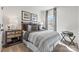 Bright bedroom with striped bedding, wooden nightstand, and window curtains at 1605 Blanche St, Charlotte, NC 28262