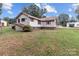 Tan house exterior with a deck and partially visible yard at 902 Oval St, Kannapolis, NC 28081