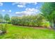 Landscaped backyard with lush greenery and fence at 8928 Carneros Creek Rd, Charlotte, NC 28214