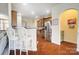 Kitchen with breakfast bar, stainless steel refrigerator, and hardwood floors at 8928 Carneros Creek Rd, Charlotte, NC 28214