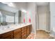 Elegant bathroom with double sinks, a large mirror, and a shower at 8928 Carneros Creek Rd, Charlotte, NC 28214