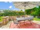 Cozy patio seating area with umbrella and stone wall at 8928 Carneros Creek Rd, Charlotte, NC 28214