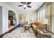 Bright living room with wicker furniture and ceiling fan at 8928 Carneros Creek Rd, Charlotte, NC 28214
