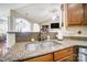 Kitchen with granite countertops, double sink, and views into Gathering room at 8928 Carneros Creek Rd, Charlotte, NC 28214