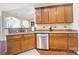 Kitchen boasts stainless steel dishwasher and wood cabinets at 8928 Carneros Creek Rd, Charlotte, NC 28214