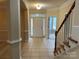 Elegant foyer with tile flooring, high ceilings, and a staircase at 2567 Old Ashworth Nw Ln, Concord, NC 28027