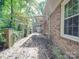 Spacious wooden deck with brick wall and leafy surroundings at 3028 Mt Vernon Dr, Gastonia, NC 28056