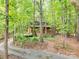 Log cabin home with a long driveway and surrounding woods at 5082 Mount Carmel Rd, Heath Springs, SC 29058