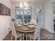 Charming dining room with round wooden table and white chairs at 13050 Regent Grove Ln, Huntersville, NC 28078