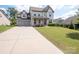 Two-story home with attached two-car garage and landscaped yard at 775 Kathy Dianne Dr, Fort Mill, SC 29707