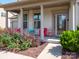 Inviting front porch with columns, seating, and colorful landscaping at 775 Kathy Dianne Dr, Fort Mill, SC 29707