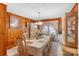 Dining room with wood paneling and large table at 1736 Woodland Dr, Charlotte, NC 28205