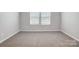 Bright bedroom with neutral carpeting and window blinds at 2235 Hedgecliff Rd # 4, Kannapolis, NC 28025