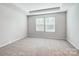 Well-lit bedroom with carpet flooring and two windows with blinds at 2235 Hedgecliff Rd # 4, Kannapolis, NC 28025