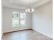 Bright dining room with hardwood floors, large windows, and a chandelier at 233 Winford Rd, Troutman, NC 28116