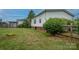 Landscaped backyard with wooden fence and spacious green lawn at 9756 Knightbridge Dr, Concord, NC 28025