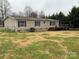 Back of manufactured home with deck and large yard at 2459 Albany Dr, Newton, NC 28658