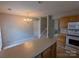 Bright kitchen with wood cabinets, island, and view into dining area at 10568 Broken Branch Rd, Charlotte, NC 28213