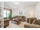 Cozy living room features a brown sofa and chairs, coffee table, and large windows at 204 Wesley Manor Dr, Matthews, NC 28104